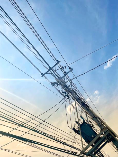 istock electric poles and complicated cables under the blue sky 1546897094