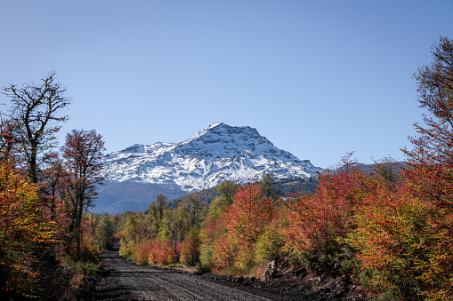 Gravel road to Tolhuaca volcano at autumn in La Araucania region, southern Chile