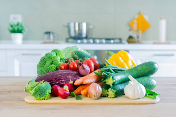 istock Stylish modern kitchen with vegetables on the table. Bright white kitchen with homewares. The concept of a healthy lifestyle. 1546950370