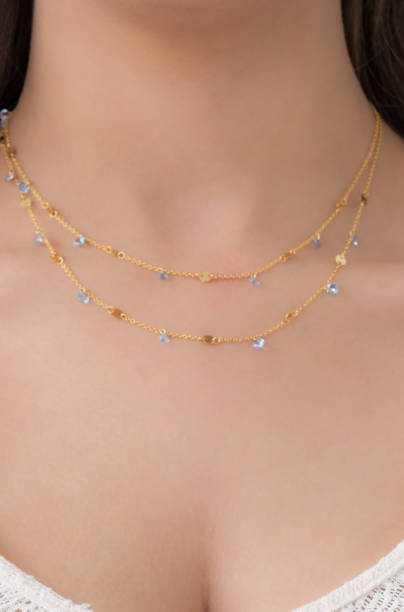 istock Young woman wearing a double layered necklace. 1546955347