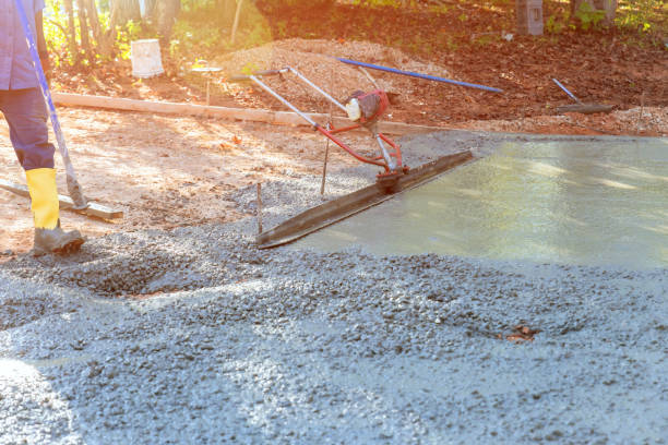 istock Worker on building site are leveling concrete for driveway with a slump concrete trowel 1546988057