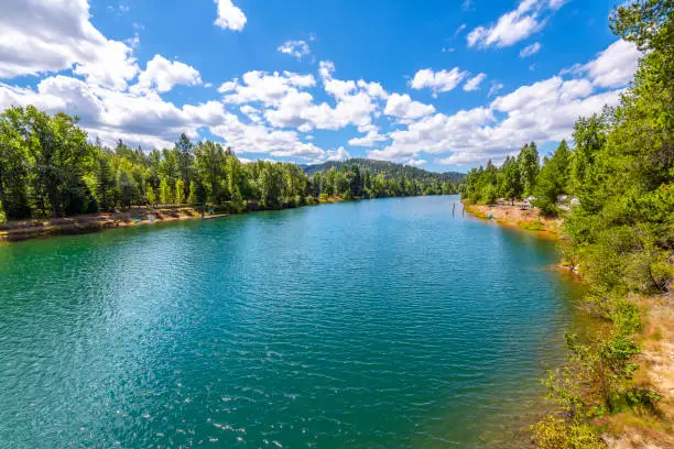 Photo of Summer day view of the Coeur d'Alene River as it runs past Rose Lake along the White Pine Scenic Byway in the rural countryside near Coeur d'Alene, Idaho USA.