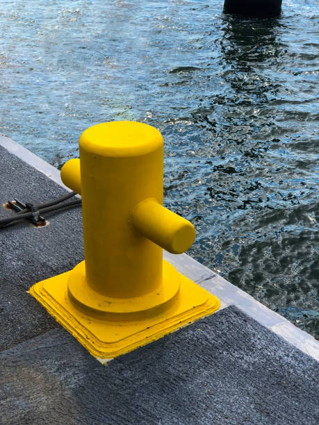 Yellow color bollard on the dock stock photo