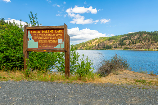A lakeside information sign along the shores of Lake Coeur d'Alene at Wolf Lodge Bay in Coeur d'Alene, Idaho USA