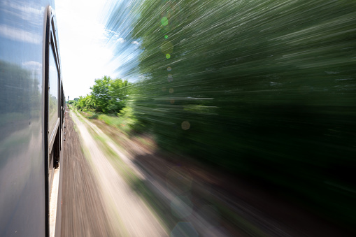 Leaning out from a moving train with blurry environment