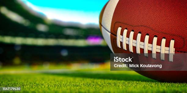 American Football Ball On Grass Of Football Stock Photo - Download Image Now - American Football - Sport, American Football - Ball, Stadium