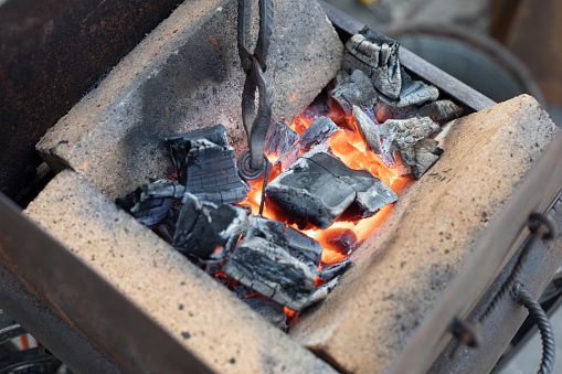 Hot coals. Incandescent furnace. Metal melting. Blacksmith's Job.