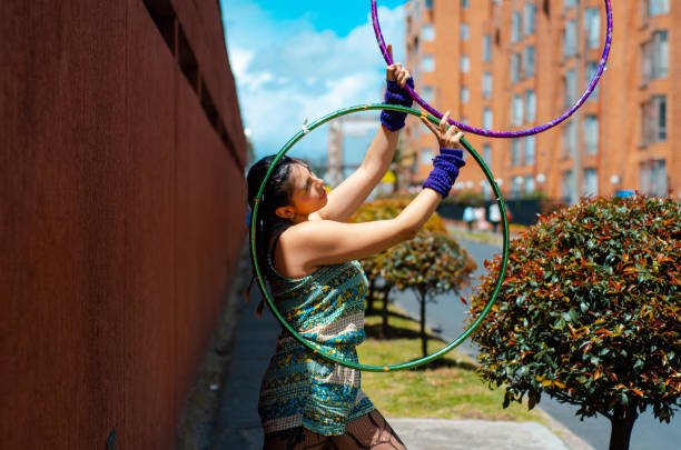woman playing with hula hoop in the Street stock photo