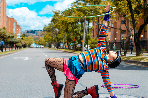 woman playing with hula hoop in the Street