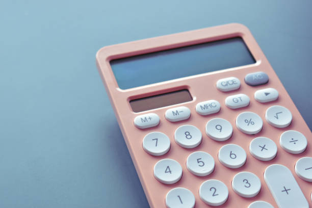 istock close up modern peach colour pastel calculator and white button on blue background, business and finance accounting concept 1547291513
