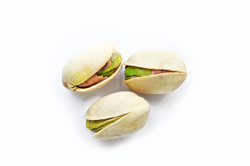 Close up of Pistachios nuts  on a white background. raw unsalted pistachios nuts