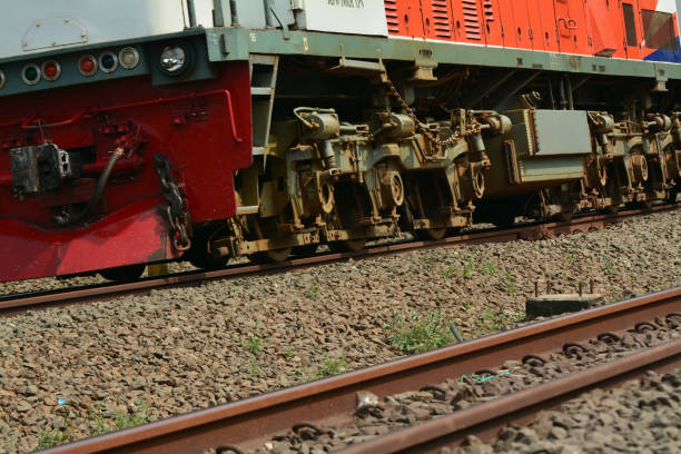 A dynamic image capturing a passenger train speeding along a railroad track in Jakarta, Indonesia. The train’s motion is captured against the bustling urban backdrop of Indonesia’s capital city. The photo highlights Jakarta’s vibrant transportation network, with busy streets, towering buildings, and a fast-paced city life in the background. Ideal for projects focusing on travel, transportation, or city life in Southeast Asia.