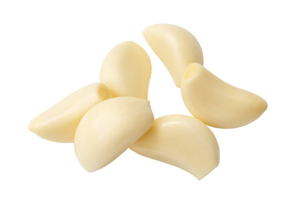 istock Peeled garlic cloves in stack isolated on white background with clipping path. 1547293222