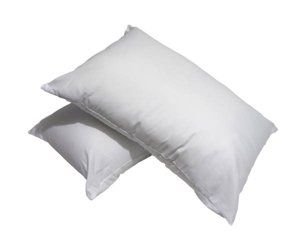 istock White pillows in stack after guest's use at hotel or resort room isolated on white background with clipping path. Concept of confortable and happy sleep in daily life 1547293270