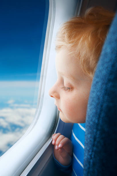 istock Boy watching sky through the airplane window 154737090