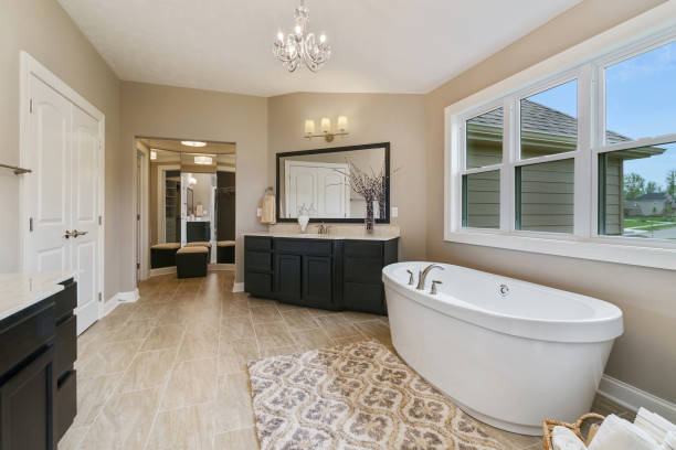 istock Spacious bathroom with dark colored vanity cabinets and tile flooring 1547403102