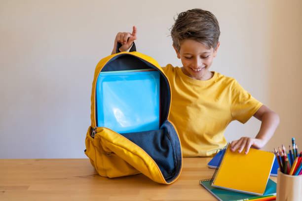 istock School Boy Smiling Puts Office Supplies In A Backpack. 1547407237