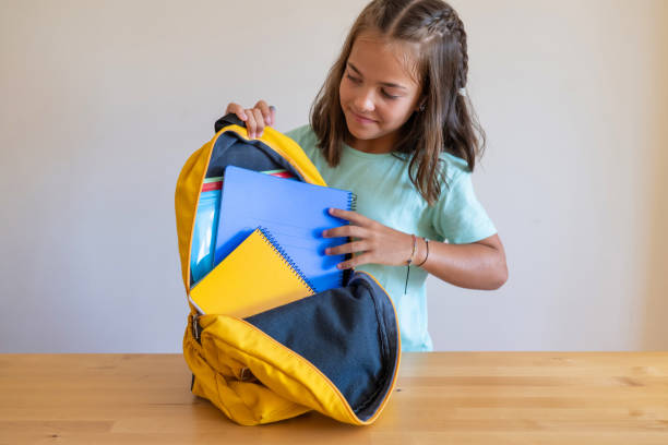 istock School Girl Smiling Puts Office Supplies In A Backpack. 1547407754