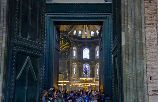 Istanbul,Turkey - August 10, 2022: Turkish and foreign tourists are visiting Hagia Sophia, in the Sultanahmet district of Istanbul. The Hagia Sophia was the main temple of Byzantium then the Muslim mosque and museum but now is Holy Hagia Sophia Grand Mosque (Ayasofya-i Kebir Cami-i Şerifi) This redesignation is controversial, drawing condemnation from the Turkish opposition, UNESCO, the World Council of Churches, the International Association of Byzantine Studies, and many international leaders.