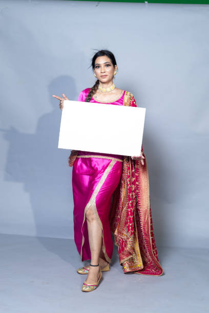 istock A Punjabi woman with sign board looking towards the camera studio shot 1547542103