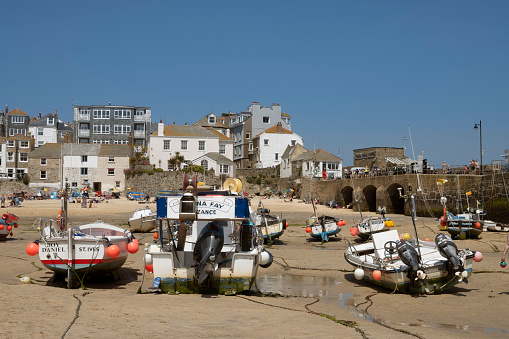 Moored Vishing Boats Rest on the Sandy Harbour at Low Tide