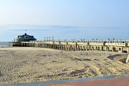 The Ocean City, MD boardwalk which has just been re-opened during the COVID-19 outbreak with social distancing being enforced by taping off two out three benches on both sides. Even with the opening of the boardwalk and beach very few people are choosing to come to this beach town
