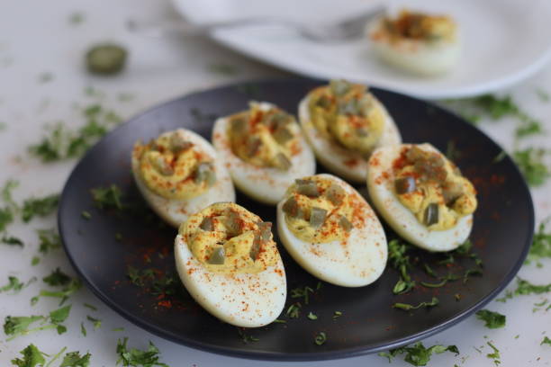 istock Stuffed eggs. Hard boiled eggs cut into half and stuffed with a paste made with egg yoks, mixed with mayonnaise and mustard 1547630481