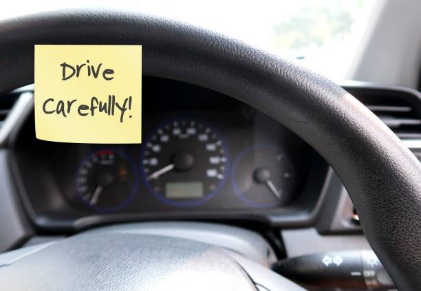 istock Car console panel with handwritten stick note DRIVE CAREFULLY , concept of car driver self reminder to to drive carefully with mindset of safety first, be alert to reduce accidents on the road 1547649328