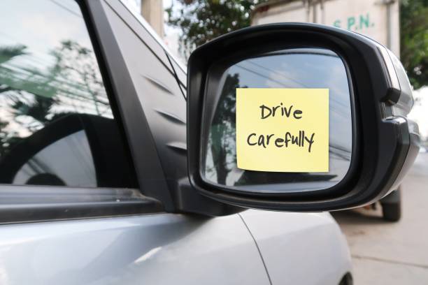 istock Car side mirror with handwritten stick note DRIVE CAREFULLY,concept of car driver self reminder to to drive carefully with mindset of safety first, be alert to reduce accidents on the road 1547649873