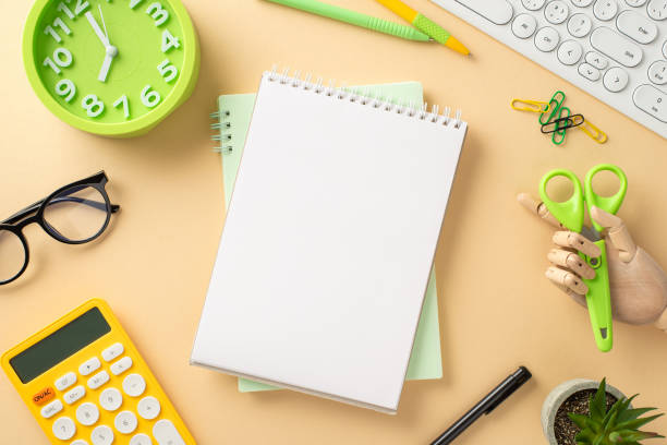 istock Embrace the convenience of distant learning with this top-down creative photo featuring a keyboard, stationery and ample page of notepad, available for text or ads, on a beige background 1547656707