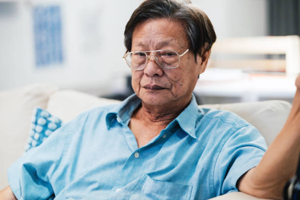 istock Senior man sitting on sofa in living room 1547673531