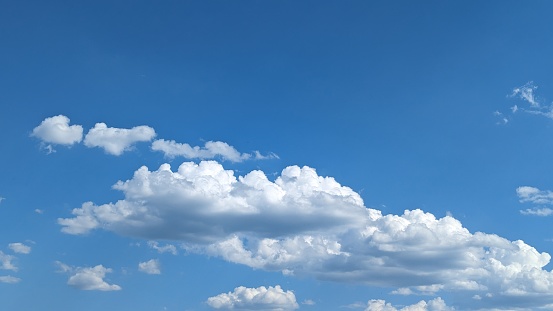 Panoramic skyscape of clouds in a blue sky in summer.