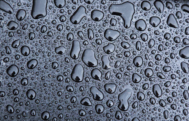 istock Drops of water on a black background close-up. 1547743084