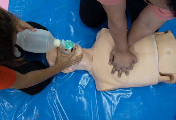 istock First aid CPR chest pumping. Instructor showing resuscitation technique with holding oxygen mask. Basic life support training. 1547752621