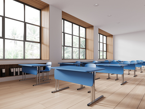 White classroom interior with blue desk and chairs in row, side view hardwood floor. Minimalist audience space with furniture. Panoramic window on tropics view. 3D rendering