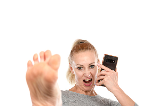 Woman kicking with a cell phone.