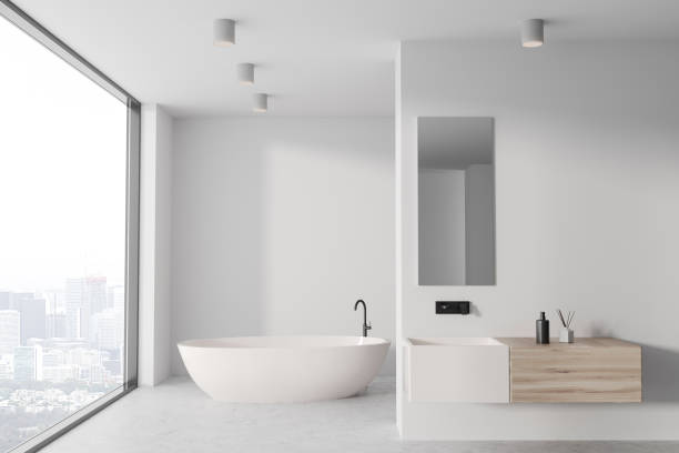 istock Stylish bathroom interior with sink and bathtub, window and mockup wall 1547770164