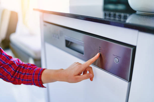 istock Female finger presses start button of dishwasher 1547795542
