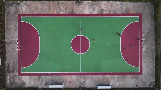 Sports grounds for team games near school building and construction site on autumn day bird eye view. Urban structure