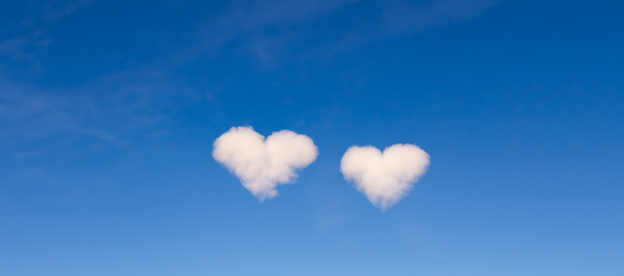 love concept image. clouds in the shape of two hearts in the blue sky