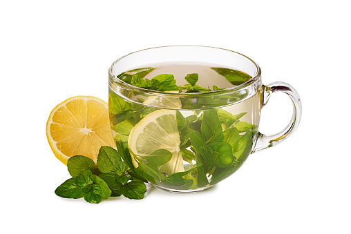 Glass teacup with herbal tea and lemon isolatrd on white background