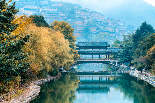 Scenery of Fengyu Bridge in Miao Village, Xijiang, Guizhou, China Scenery of Fengyu Bridge in Qianhu Miao Village, Xijiang, Guizhou, China qiandongnan miao and dong autonomous prefecture stock pictures, royalty-free photos & images