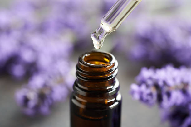 istock Dropping lavender essential oil into a brown glass bottle 1547932112