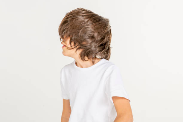 Portrait of a young boy. 10 year old boy jumping on white background. White t-shirt and red sweatpants. white people.