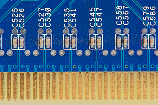 Close up of a circuit board for an electronic circuit with gold plated terminal lugs