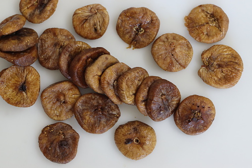 Dried Anjeer or figs from Jordan. Big and fleshy dry figs grown in jordan. They are sweet in flavour and have a leather like texture. These are soft and chewy to eat. Shot on a white background