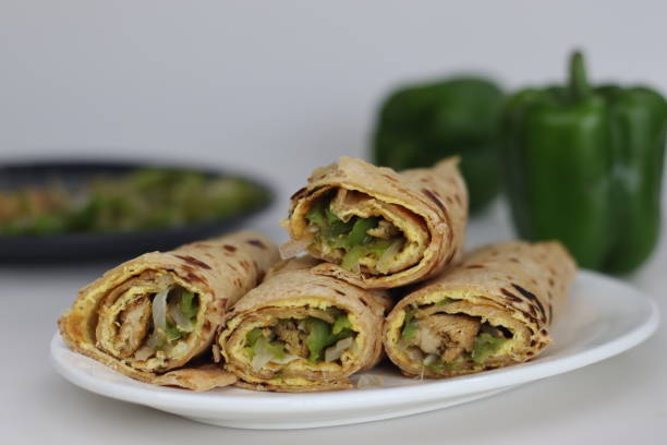 istock Chicken and egg wrap or Egg chicken roll. Stir fried bell peppers and minced chicken wrapped in whole wheat flat bread along with egg omelet 1548001966