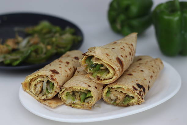 istock Chicken and egg wrap or Egg chicken roll. Stir fried bell peppers and minced chicken wrapped in whole wheat flat bread along with egg omelet 1548001967