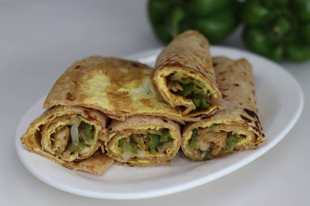 istock Chicken and egg wrap or Egg chicken roll. Stir fried bell peppers and minced chicken wrapped in whole wheat flat bread along with egg omelet 1548001969