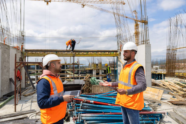 istock Male Caucasian engineer and architect at the construction site working together 1548126511